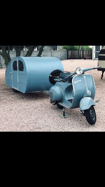 Vintage Vespa Scooter With A Camping Trailer Attached